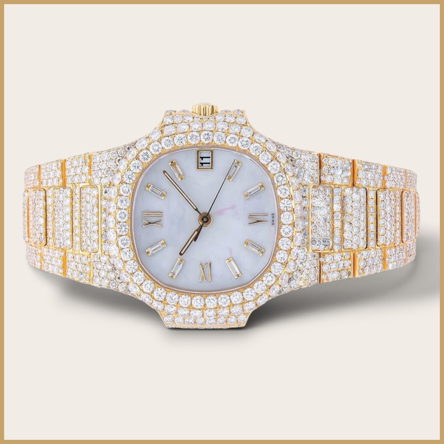 Gold tone watch with a pearl dial and Roman numerals